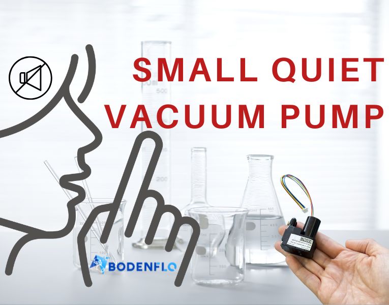 A small, quiet vacuum pump held in a hand with laboratory equipment in the background, emphasizing low noise and compact design.