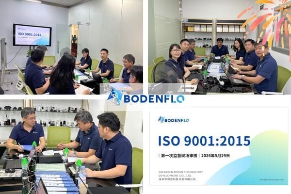 A photo of the BODENFLO team and an ISO auditor reviewing process documents on a factory floor